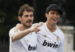 Real Madrid's goalkeeper Iker Casillas, left, and Cristiano Ronaldo celebrate at Cibeles square after Real Madrid won the Spanish Soccer La Liga, in Madrid, Thursday, May 3, 2012. Madrid won 3-0 at Athletic Bilbao on Wednesday for its first league championship since 2008, forcing Barcelona to relinquish the title after three straight years. Jose Mourinho became the first coach to win titles in four different European leagues.