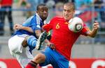 Gilles Sunu of France and Oriol Romeu, of Spain, challenge for the ball during the UEFA European Under-19 Championship final soccer match, between France and Spain, at Michel d'Ornano stadium, Friday, July 30, 2010, in Caen, northwestern France.