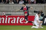 Paris Saint-Germain's Javier Pastore from Argentina, center, challenges for the ball with Caen's Gregory Proment during their League One soccer match, in Paris, Saturday Oct. 29, 2011.