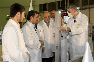 This photo released by the Iranian President's Office, claims to show Iranian President Mahmoud Ahmadinejad, second left being escorted by technicians during a tour of Tehran's research reactor centre in northern Tehran, Iran, Wednesday Feb. 15, 2012.