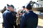 On the flightline next to a US Air Force (USAF) F-16 Fighting Falcon, USAF Colonel (COL) Robert Murphy (right center), Commander, 183rd Fighter Wing, Illinois Air National Guard (ILANG), briefs USAF COL Patrick Rosenow (in leather jacket), Article 32 Investigating Officer, on aspects of the pilot's HGU-55/P helmet with AN/AVS-9 Night Vision Goggles (NVG) attached. USAF COL Rosenow is investigating the Tarnak Farms Friendly Fire incident that killed four Canadian soldiers and injured eight near K