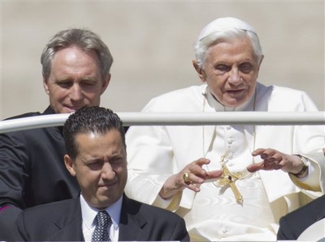 In this photo taken Wednesday, May, 23, 2012, Pope Benedict XVI, flanked by his private secretary Georg Gaenswein, top left, and his butler Paolo Gabiele arrives at St.Peter's square at the Vatican for a general audience. The Vatican has confirmed Saturday, May 26, 2012, Gabriele was arrested in an embarrassing leaks scandal. Spokesman the Rev. Federico Lombardi said Paolo Gabriele was arrested in his home inside Vatican City with secret documents in his possession.