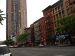 Manhattan Plaza performing artist residence and Film Center Cafe on Ninth Avenue, looking south. Hell's Kitchen's gritty reputation had made its housing prices lower than elsewhere in Manhattan.