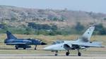 A Tornado F3 Air Defense aircraft, right, of Britains Royal Air force lands, as an Indian Air Force Mig 27 ML taxies, on the concluding day of the first Indo-Britain Air force exercise Indradhanush 2006 at the Air Force station in Gwalior, India, Friday,