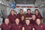 Shuttle and Station crew members pose for a portrait. The crew awakened at 4:59 UTC to a special message and a song from Sir Paul McCartney.