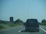 The Garden State Parkway with an advance sign for the John B. Townsend Shoemaker Holly picnic area. One of the objectives of the Parkway was to become a State Park its entire length and its users would enjoy parklike aesthetics with minimal intrusion of urban scenery