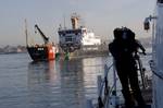 SAN DIEGO A CNN cameraman, Gregg Canes, films the Coast Guard Cutter George Cobb, a 225-foot buoy tender homeported in San Pedro, Calif., while aboard the Cutter Petrel, an 87-foot patrol boat homeported in San Diego, Wednesday, Feb. 17, 2010. Canes spent the evening underway with the Petrel and was heading back into port when the cameraman and Petrel crew spotted the Cobb servicing buoy number 19 in San Diego Bay. U.S. Coast Guard photo by Petty Officer 1st Class Allyson E.T. Conroy. (788757) (