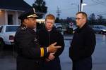 NEW ORLEANS (Jan. 9, 2003) -- Capt. Marlon A. Defillo of the New Orleans Police Departmant speaks with Petty Officer 3rd Class Robert Jenkins and Petty Officer 2nd Class Orin Augustus, gunner's mates from Coast Guard Atlantic Area Armory in Belle Chasse, La., Jan. 9 right before a live television interview on CNN News. Jenkins, 21, of Tarpon Springs, Fla., and Augustus, 34, of Sioux Falls, S.D., assisted NOPD officers in the apprehension of bank robbery suspects during an attempted robbery in Al