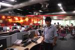 A Tibetan reporter visiting one of departments of CNN, IBN media agency based in Delhi, India