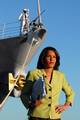 A Sailor aboard the Pearl Harbor-based guided-missile destroyer USS Russell (DDG 59) waits to perform colors as CNN correspondent Suzanne Malveaux prepares to do a live broadcast from the pier of Naval Station (NAVSTA) Pearl Harbor.