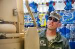 Staff Sgt. Gregory Beard of Henderson, Ky., truck driver and ammunition section chief in Company D, 113th Support Battalion, delivers bottled water to residents of Henryville, Ind., March 4, 2012, after a large tornado swept the area. The National Guard is drawing down forces in the area as local emergency response and civil service units carry on rebuilding efforts.