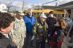 Indiana Gov. Mitch Daniels speaks with the media from the debris ridden streets of Henryville, Ind., March 3, 2012, after a large tornado damaged much of the town less than 24 hours prior.