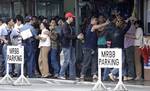 Hostages, left, are secured by police officers as unidentified men are handcuffed by plain-clothes officers at the end of a hostage taking inside a bank in Cavite province, south of Manila, Philippines on Thursday, Oct. 13, 2011.