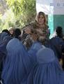 U.S. Army Lieutenant Colonel Pam Moody wears a hijab while she distributes pencils to Afghan women on International Women's Day