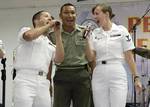 Musician 1st Class Bradley Blanchard and Musician 3rd Class Nina Church, both assigned to the U.S. 7th Fleet Rock Band Orient Express, sing the Beatles song