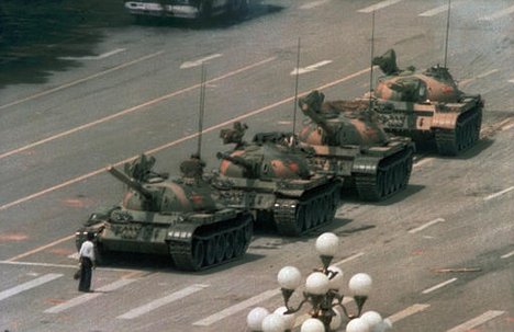 File - A Chinese man stands alone to block a line of tanks heading east on Beijing's Cangan Blvd. in Tiananmen Square on June 5, 1989.