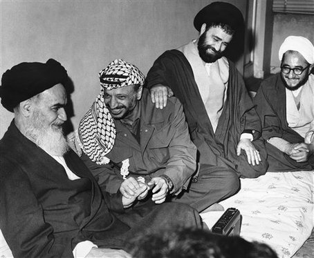 In this Feb. 18, 1979 file picture, Ayatollah Ruhollah Khomeini, left, smiles with Yasser Arafat in Tehran.