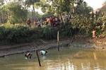 INDIA-VILLAGER-RECOVER-EMPTY-CATRIDGES-PONDThe CBI officials seen standing beside a pond in Netai village of Lalgarh on Sunday from where empty cartridges were recovered as evidence of carnage in Eastern India ------ WN/BHASKAR MALLICK