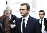 Andy Coulson, the former editor of the News of the World newspaper and former director of communications for Britain's Prime Minister David Cameron, leaves after appearing at the Leveson Inquiry at the High Court in central London, Thursday, May 10, 2012.