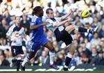 Chelsea's Didier Drogba, center, vies for the ball against Bolton's David Wheater, right, during their English Premier League soccer match at Stamford Bridge, London, England, Saturday Feb. 25, 2012.