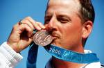 Straight on, close-up shot of James Graves as he kisses the Bronze Medal he won in the Men's Skeet competition Saturday, September 23rd, 2000, during the 2000 Olympics in Sydney, Australia.