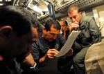 Navy Diver 1st Class Gene Perez reviews operational procedures as the U.S. Navy Submarine Rescue Diving and Recompression System's (SRDRS) Pressurized Rescue Module (PRM), Falcon, mates with SSK Tridente (S 70).