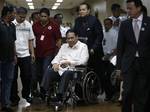 Philippine Supreme Court Chief Justice Renato Corona is pushed on a wheelchair by his son Francis shortly after testifying for the second time in his impeachment trial Friday May 25, 2012 before the senator-judges acting as an impeachment court in Manila, Philippines. Corona on Tuesday read a lengthy testimony and 