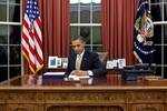 United States President Barack Obama signs H.R. 3630 - Middle Class Tax Relief and Job Creation Act of 2012 (Payroll Tax Cut Extension) in the Oval Office on 22 February 2012.