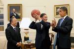 Chinese Vice Premier Wang Qishan, center, holds the autographed basketball given to him by President Barack Obama following their Oval Office meeting Tuesday, July 28, 2009, to discuss the outcomes of the first U.S.-China Strategic and Economic Dialogue. Looking on at left is Chinese State Councilor Dai Bingguo.