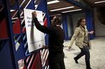 A worker puts up a sign on the gate of a subway station in Lisbon, Wednesday night, Nov. 23, 2011, at the start of a general strike as trade unions protest austerity measures linked to a euro78 billion (US$104 billion) international bailout.