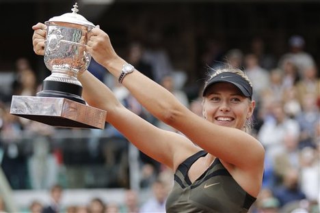 Maria Sharapova of Russia holds the trophy after winning the women's final match against Sara Errani of Italy at the French Open tennis tournament in Roland Garros stadium in Paris, Saturday June 9, 2012.