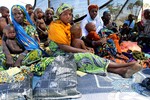 File - Niger Families Face Drought and Rising Food Prices: Mothers wait to have their children assessed and weighed at the a therapeutic feeding centre in Bargadja, Maradai Region, Niger.