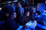 U.S. Navy and Japanese Maritime Self-Defense Force personnel stand watch in the Combat Direction Center (CDC) aboard the conventionally powered aircraft carrier USS Kitty Hawk (CV 63).