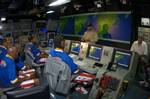 The Harlem Globetrotters receive a brief during a tour of the Combat Direction Center (CDC) aboard USS Kitty Hawk (CV 63).