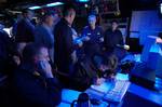 U.S. Navy and Japanese Maritime Self-Defense Force personnel stand watch in the Combat Direction Center (CDC) aboard the conventionally powered aircraft carrier USS Kitty Hawk (CV 63).