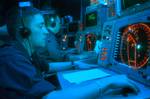 Operations Specialist Seaman Jeffrey R. Rinker of Harpers Ferry, W.Va., stands watch in the Combat Direction Center (CDC) aboard USS Kitty Hawk (CV 63).