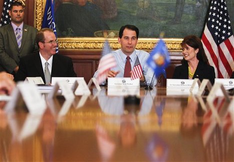 Wisconsin Gov. Scott Walker, center, holds his first cabinet meeting at the state Capitol Wednesday, June 6, 2012, in Madison, Wis., after Walker beat Milwaukee Mayor Tom Barrett in a recall election.