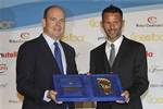 Soccer player Ryan Giggs of Wales , right, receives from Prince Albert II of Monaco, his 'Golden Foot' award during the 'Golden Foot 2011' awards in Monaco, Monday, Oct. 10, 2011.