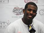 NBA player Chris Paul answering questions at a youth basketball camp.