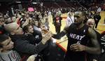 Miami Heat's LeBron James (6) receivers high-fives from fans after their NBA basketball game with the Portland Trail Blazers Thursday, March 1, 2012, in Portland, Ore. The Heat deated the Trail Blazers 107-93. (AP Photo/Rick Bowmer)