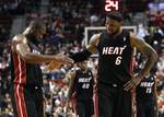 Miami Heat's Dwyane Wade and teammate Miami Heat's LeBron James (6) celebrate their victory following the NBA basketball game with the Portland Trail Blazers Thursday, March 1, 2012, in Portland, Ore. (AP Photo/Rick Bowmer)