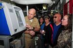 Capt. David Pimpo demonstrates the use of a Navy Cash machine to a group from the Department of the Treasury aboard USS Wayne E. Meyer (DDG 108).