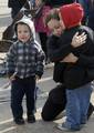 Wendy Caldron, wife of Electrician's Mate 2nd Class Brian Caldron, comforts her sons as the guided-missile frigate USS Nicholas (FFG 47) departs Naval Station Norfolk.