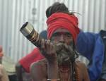 A old Indian Sadhu - Hindu holy man - blesses a pilgrim at a temporary camp in Kolkata, 08 January 2008. Thousands of Hindu pilgrims have started to converge for the Gangasagar Mela which will culminate on 14 January, on the occasion of Makar Sankranti, a holy day of the Hindu calendar, during which a dip in the ocean at the confluence of the River Ganges and the Bay of Bengal, some 150 kms south of Kolkata, is considered to be of great religious significance in Eastern India