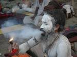 An Indian Sadhu - Hindu holy man - smokes ganja (cannabis) at a temporary camp in Kolkata, 08 January 2008. Thousands of Hindu pilgrims have started to converge for the Gangasagar Mela which will culminate on 14 January, on the occasion of Makar Sankranti, a holy day of the Hindu calendar, during which a dip in the ocean at the confluence of the River Ganges and the Bay of Bengal, some 150 kms south of Kolkata, is considered to be of great religious significance in Eastern India