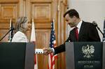 U.S. Secretary of State Hillary Rodham Clinton, left, and Polish Foreign Minister Radoslaw Sikorski shakes hands prior to holding a joint press availability, at City Hall in Krakow, Saturday, July 3, 2010.