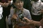 Myanmar opposition Leader Aung San Suu Kyi talks to reporters as she arrives at Yangon International airport Wednesday, June 13, 2012, in Yangon, Myanmar.