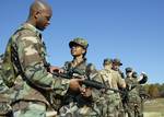 Mass Communication Specialist 2nd Class Ja'lon Rhinehart teaches Yeoman 2nd Class Rosilyn Bowie M16 rifle fundamentals.