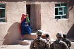 An Afghan woman exits her home so that Afghan soldiers and U.S. Army paratroopers can search it for weapons caches June 2, 2012, Ghazni Province, Afghanistan.  The paratroopers are assigned to 2nd Battalion, 504th Parachute Infantry Regiment, a line unit of the 82nd Airborne Division’s 1st Brigade Combat Team.  (U.S. Army photo by Sgt. Michael J. MacLeod)