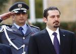 File - Lebanese Prime Minister Saad Hariri, right, looks on during a ceremony held on his first day at the Government House in downtown Beirut, Lebanon, Wednesday, Nov. 11, 2009, two days after the formation of the new Cabinet.